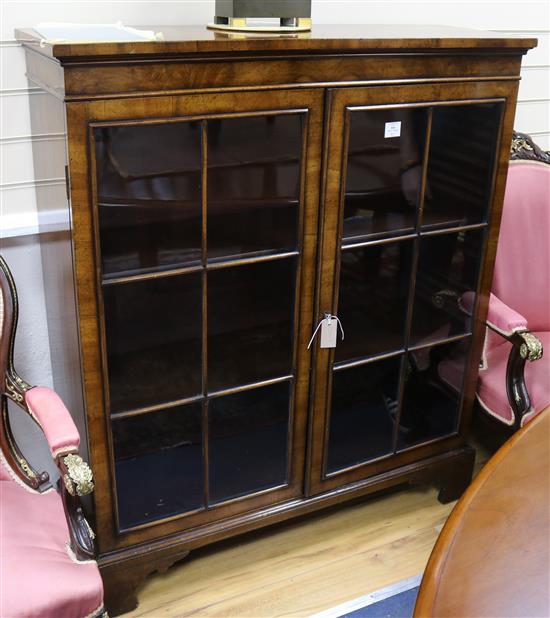 A 1930s walnut glazed two door china display cabinet, W.110cm